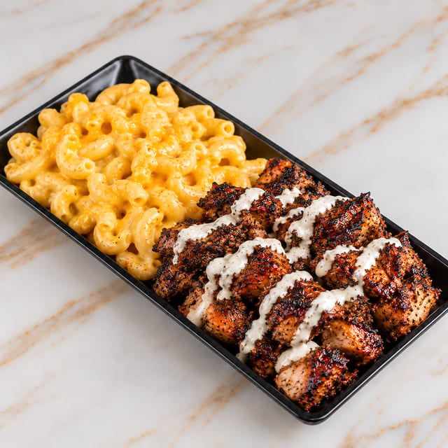 Jerk Chicken Over Mac and Cheese.