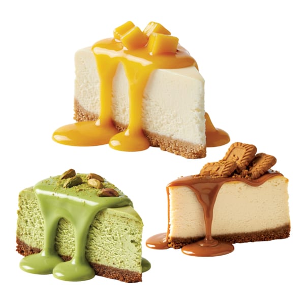 Three cheesecake slices: mango, matcha with pistachios, and caramel with Lotus Biscoff cookies.